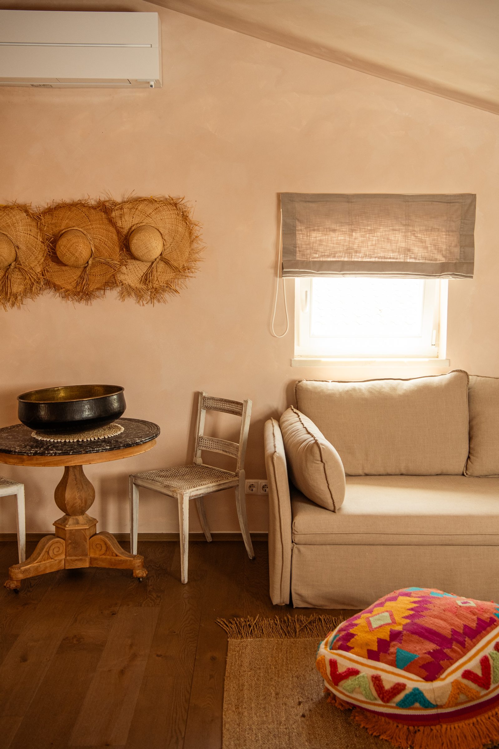 Olive Suite sitting area with woven hats and linen sofa